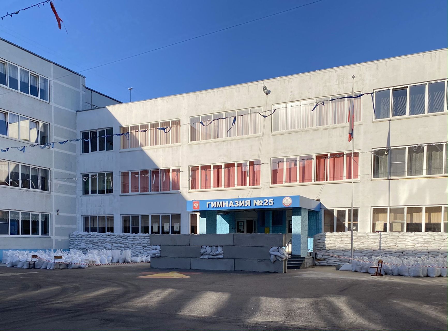 Gymnasium No. 25 and sandbags in the yard